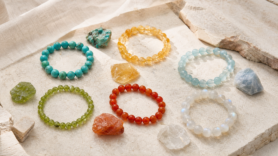 Six summer mineral bracelets in turquoise, citrine, aquamarine, peridot, carnelian, and moonstone on pale limestone